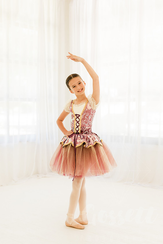 Ballerinas pose in a natural light studio