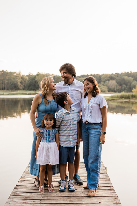 Family smiling on Cauble Park dock during spring mini session, outdoor family photography in Atlanta area.