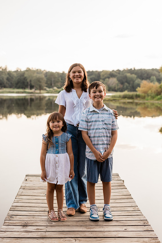 Family smiling on Cauble Park dock during spring mini session, outdoor family photography in Atlanta area.