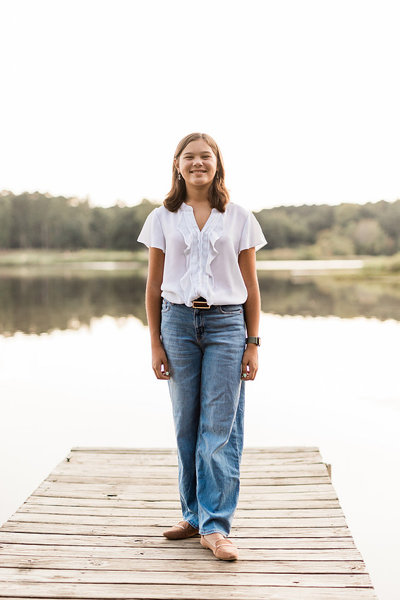 Family smiling on Cauble Park dock during spring mini session, outdoor family photography in Atlanta area.