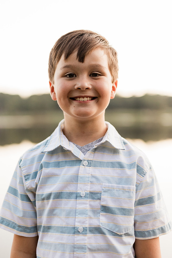 Family smiling on Cauble Park dock during spring mini session, outdoor family photography in Atlanta area.