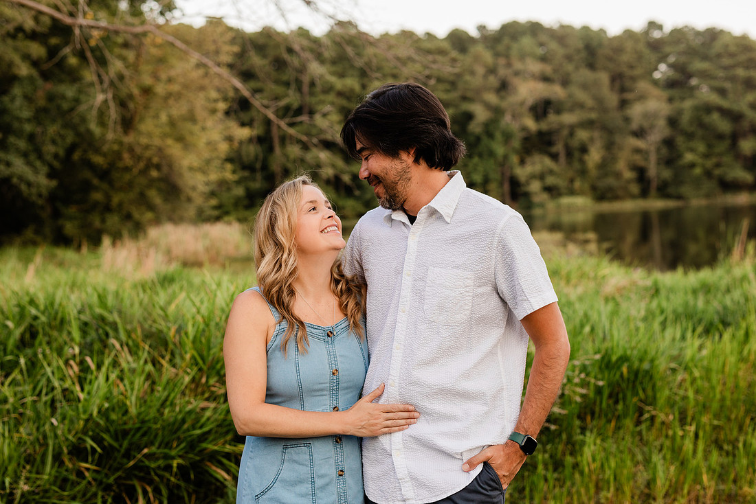 Family smiling on Cauble Park dock during spring mini session, outdoor family photography in Atlanta area.