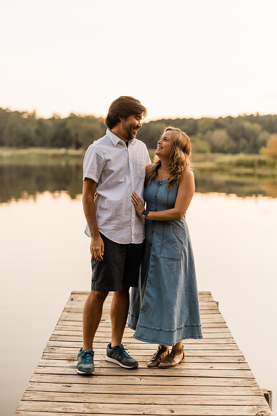 Family smiling on Cauble Park dock during spring mini session, outdoor family photography in Atlanta area.