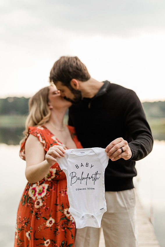 Outdoor maternity photography session with expecting parents captured in soft natural light