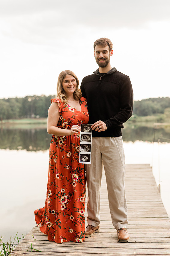 Outdoor maternity photography session with expecting parents captured in soft natural light