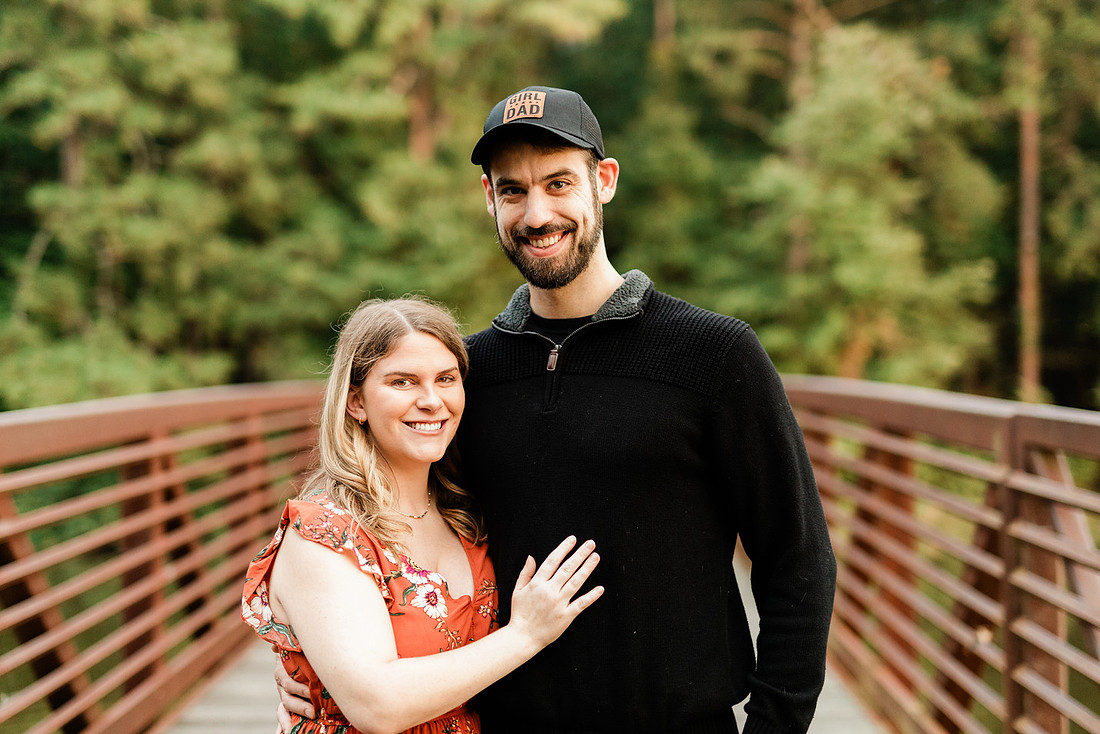Outdoor maternity photography session with expecting parents captured in soft natural light