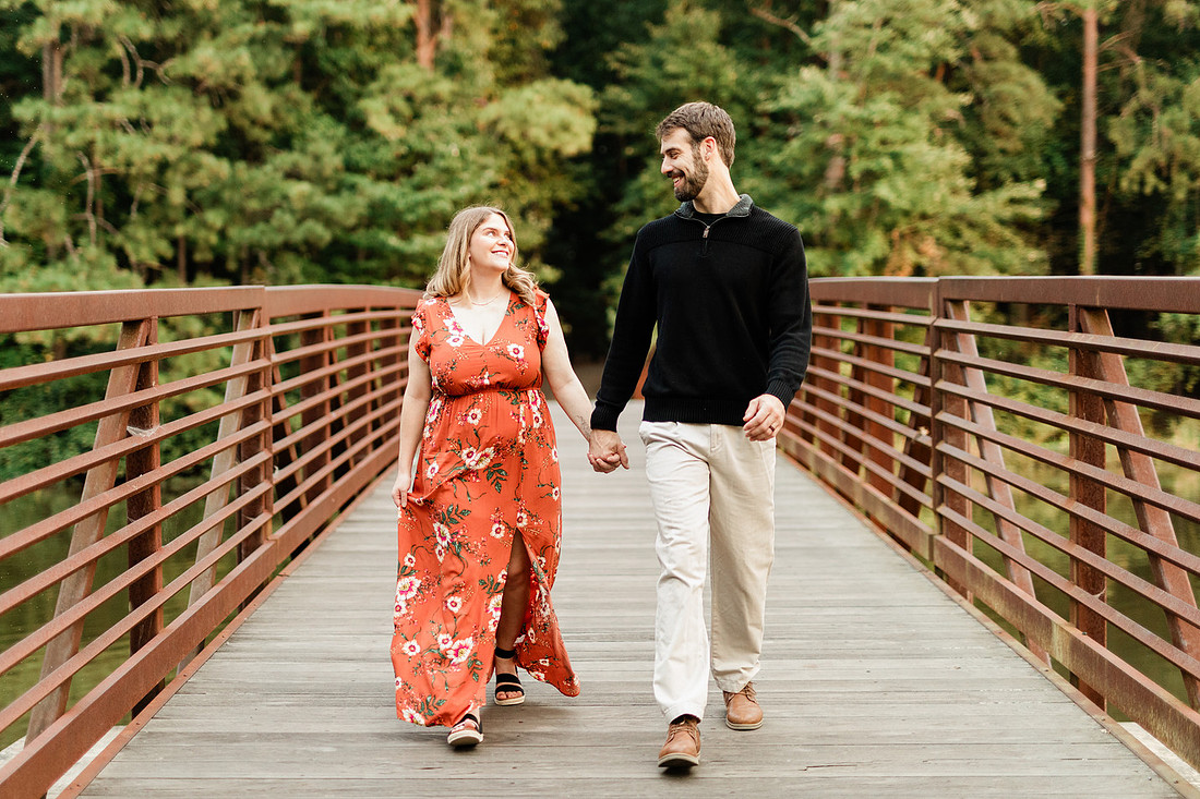 Outdoor maternity photography session with expecting parents captured in soft natural light
