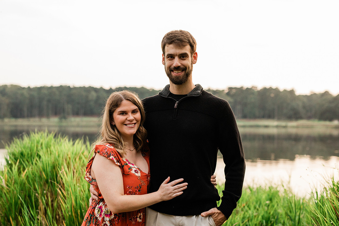 Outdoor maternity photography session with expecting parents captured in soft natural light