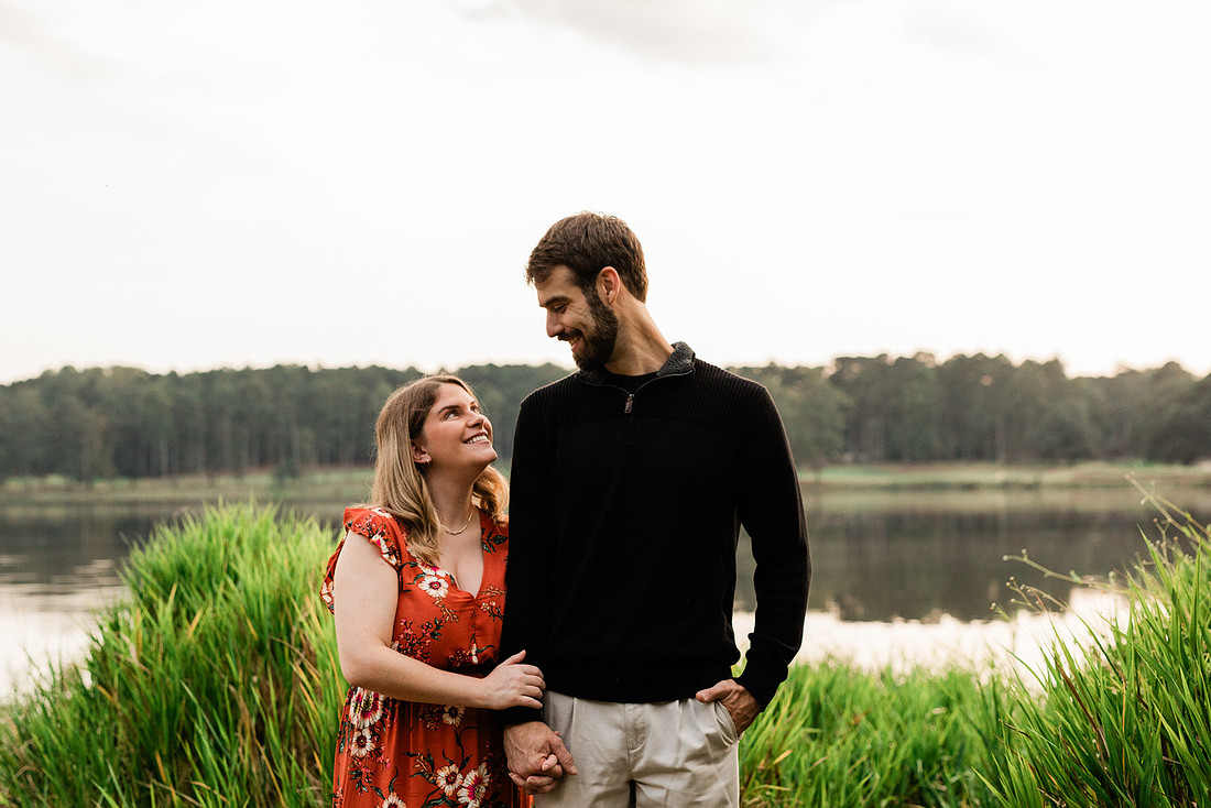 Outdoor maternity photography session with expecting parents captured in soft natural light