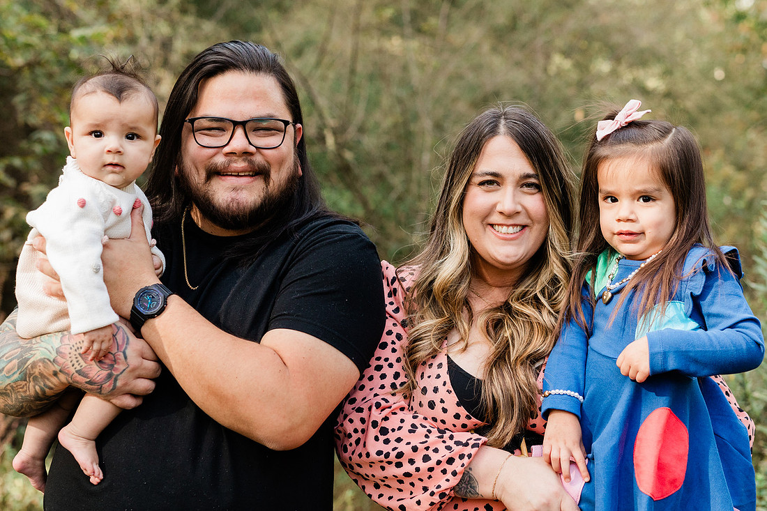 family of four connects while a photographer docoments the moment
