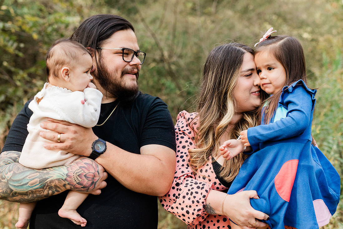 family of four connects while a photographer docoments the moment