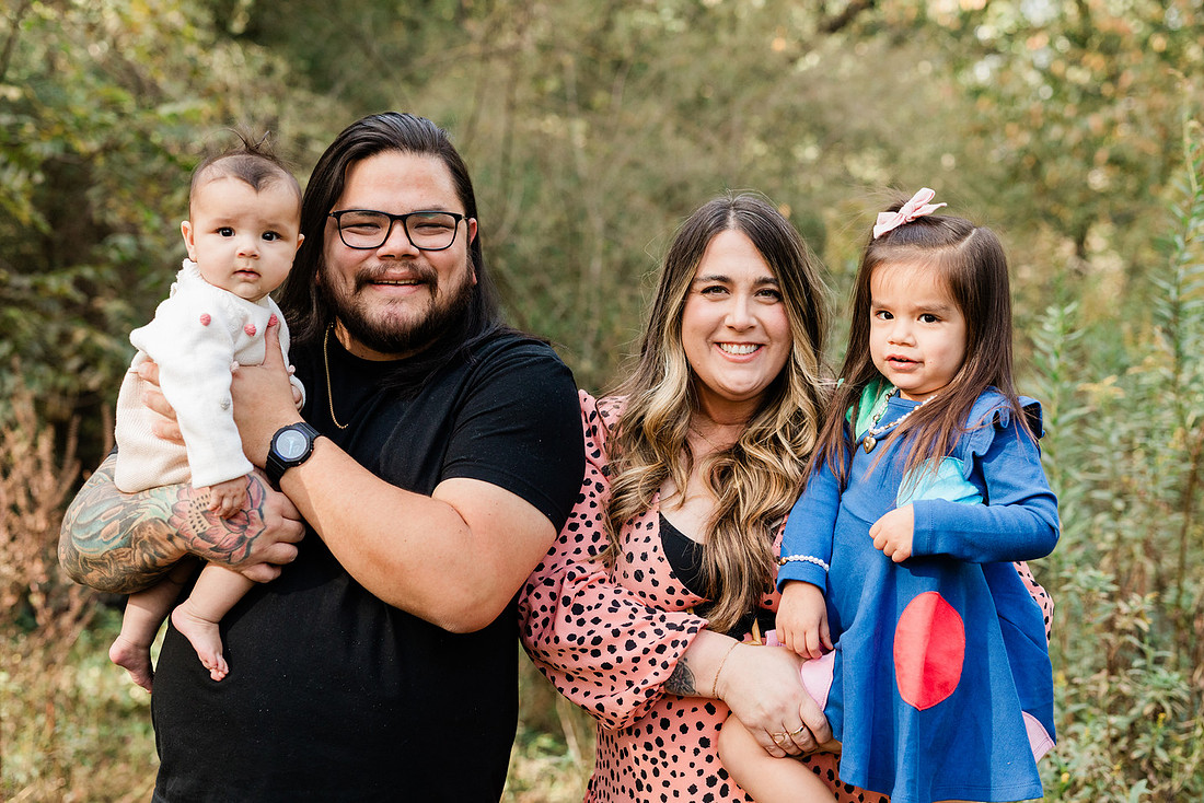 family of four connects while a photographer docoments the moment