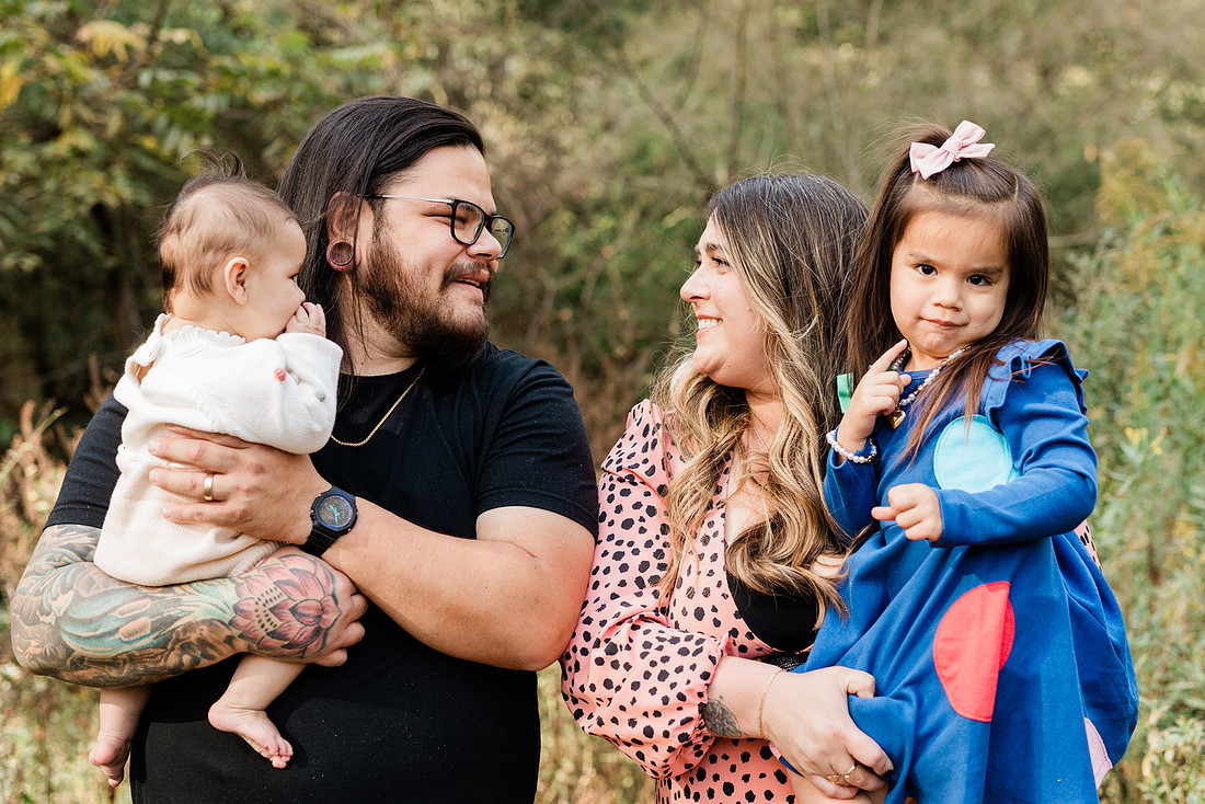 family of four connects while a photographer docoments the moment