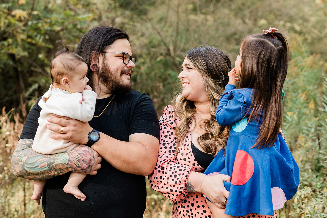 family of four connects while a photographer docoments the moment