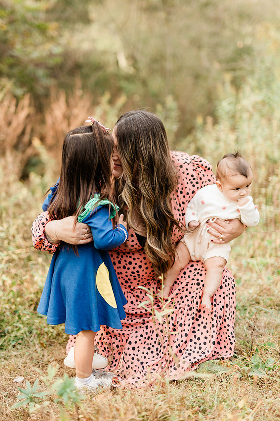 family of four connects while a photographer docoments the moment