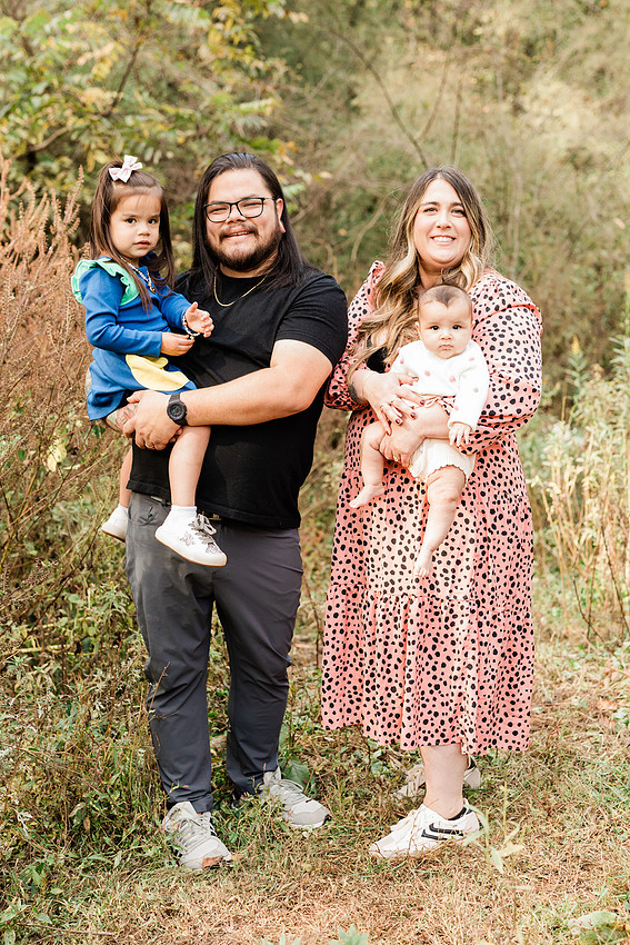 family of four connects while a photographer docoments the moment