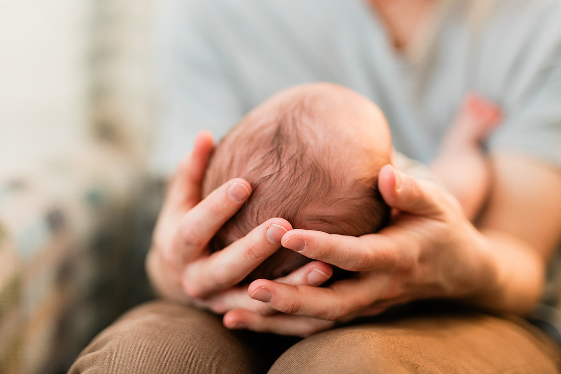 Family in their home welcoming baby