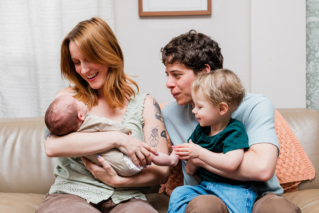 Family in their home welcoming baby
