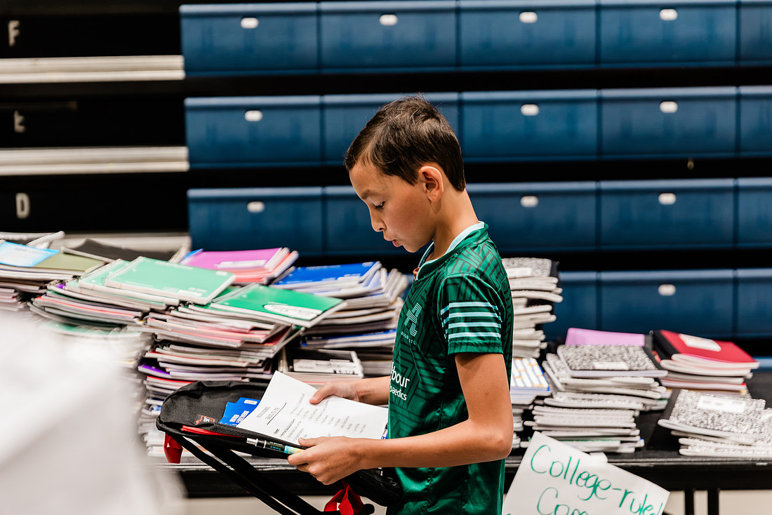 Scenes from KIDS CARE's Backing the Need backpack and school supply drive at the Cobb County Civic Center in Marietta, GA.