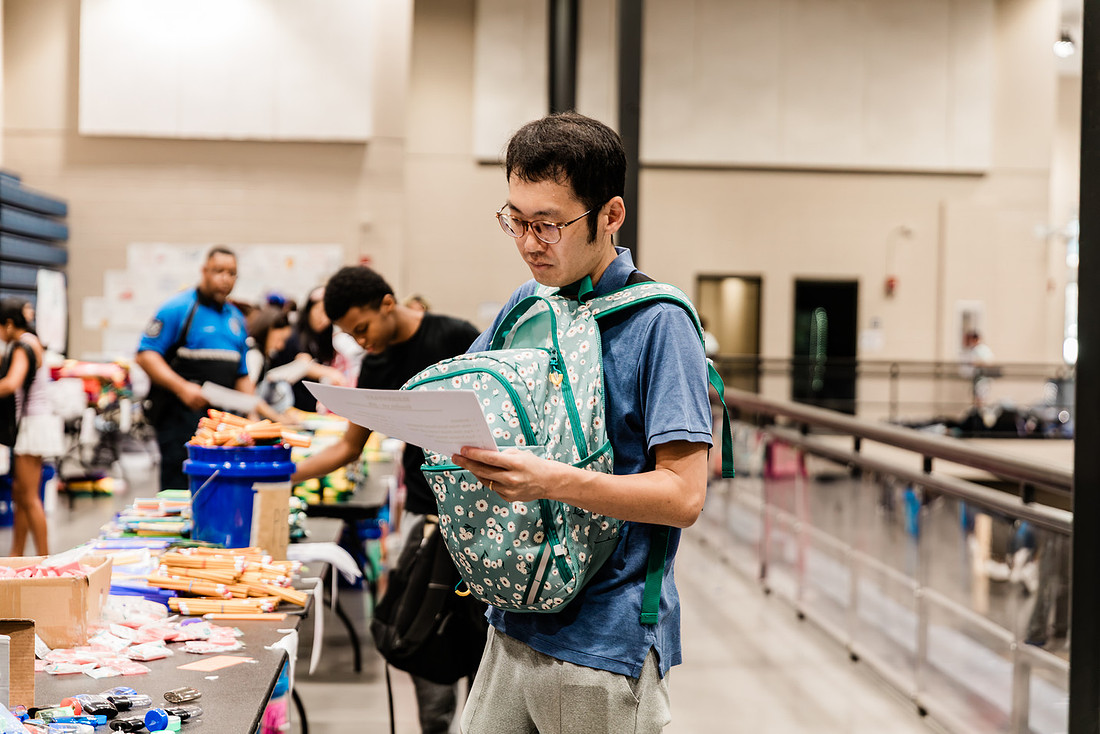 Scenes from KIDS CARE's Backing the Need backpack and school supply drive at the Cobb County Civic Center in Marietta, GA.