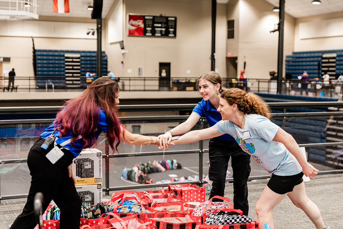 Scenes from KIDS CARE's Backing the Need backpack and school supply drive at the Cobb County Civic Center in Marietta, GA.