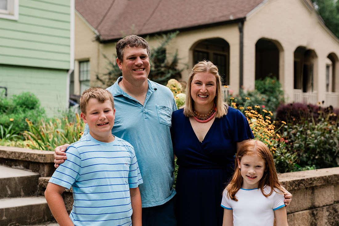 family posing on front porch