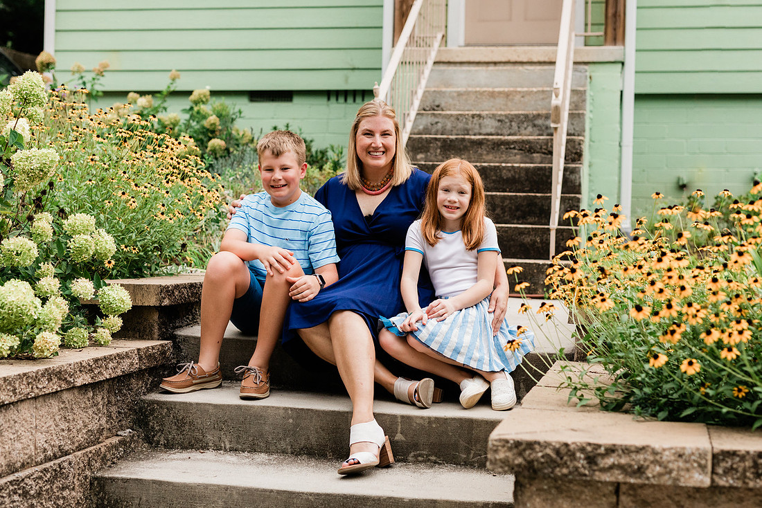 family posing on front porch