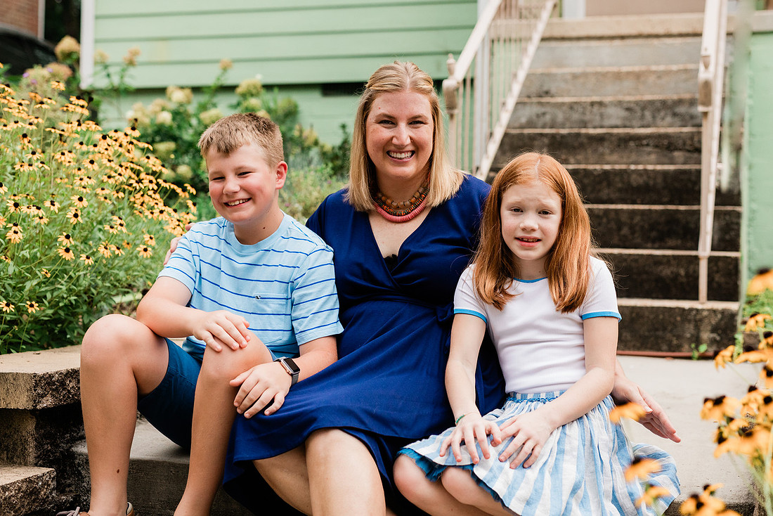 family posing on front porch