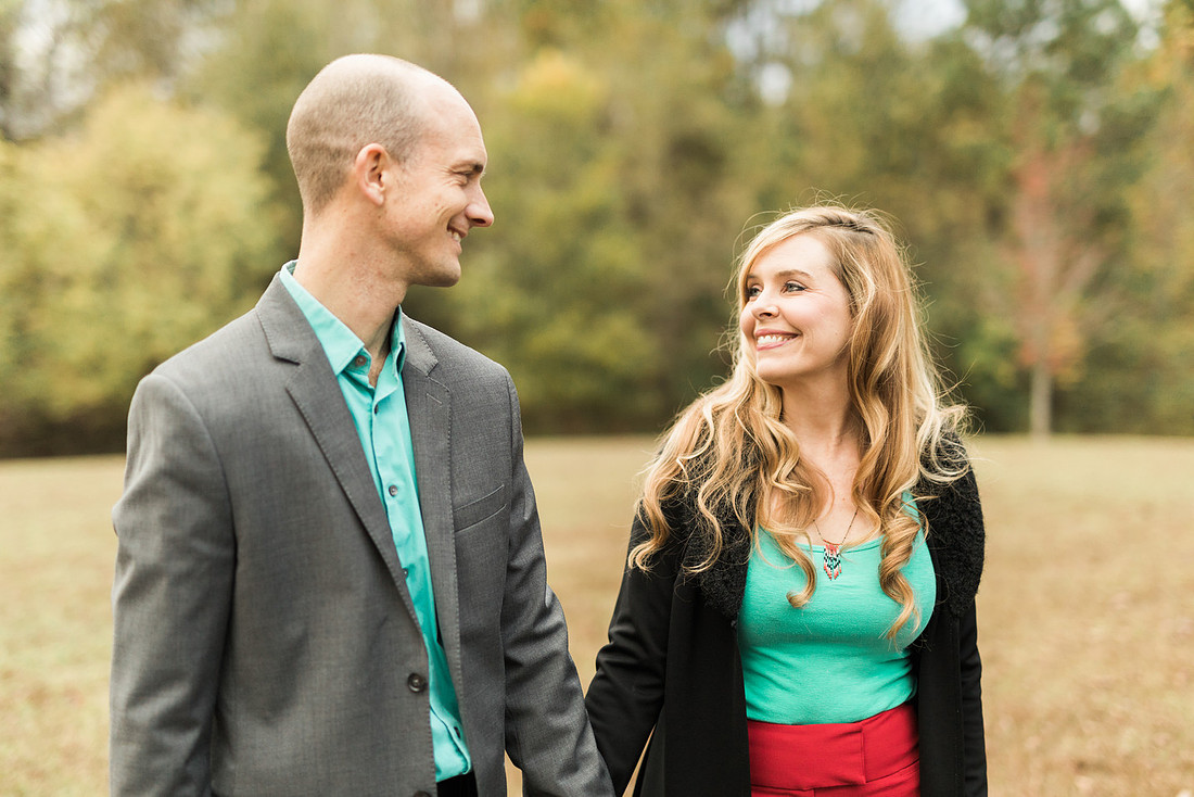 Family smiles for both posed and candid photos in a park