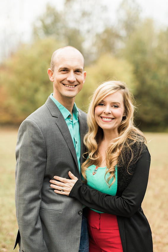Family smiles for both posed and candid photos in a park