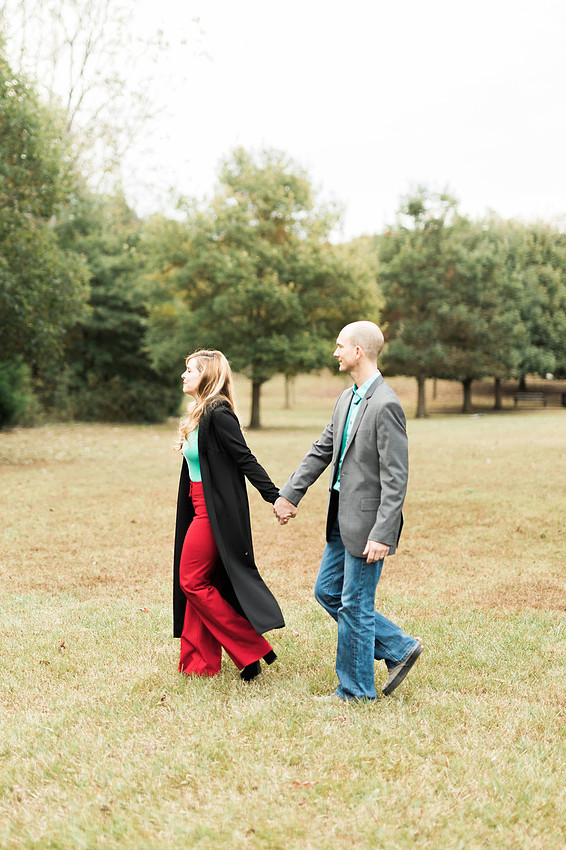 Family smiles for both posed and candid photos in a park