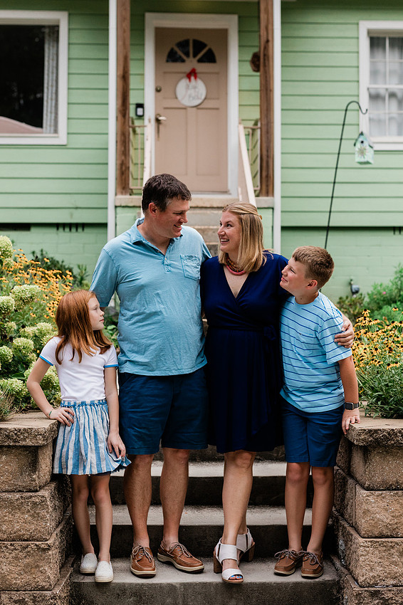 family posing on front porch