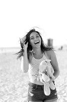 High School senior girl holding stuffed animal and laughing