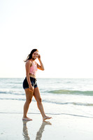 high school senior girl walking along the shoreline