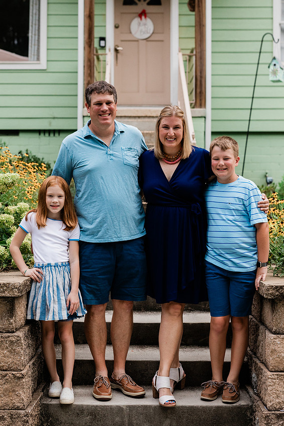 family posing on front porch