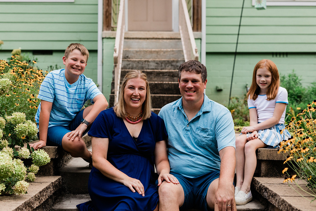 family posing on front porch