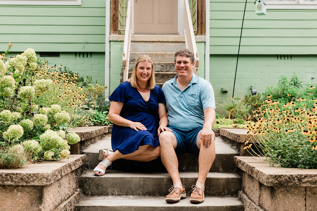 family posing on front porch