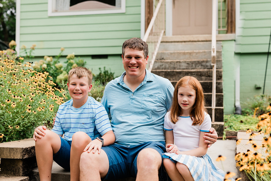 family posing on front porch