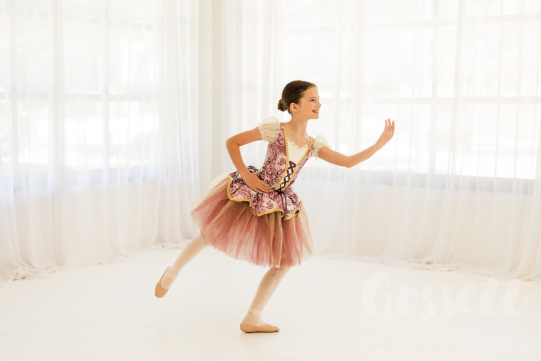 Ballerinas pose in a natural light studio