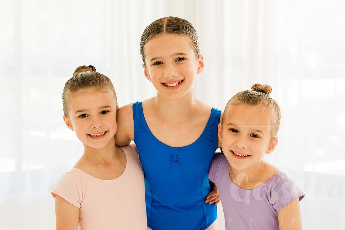 Ballerinas pose in a natural light studio