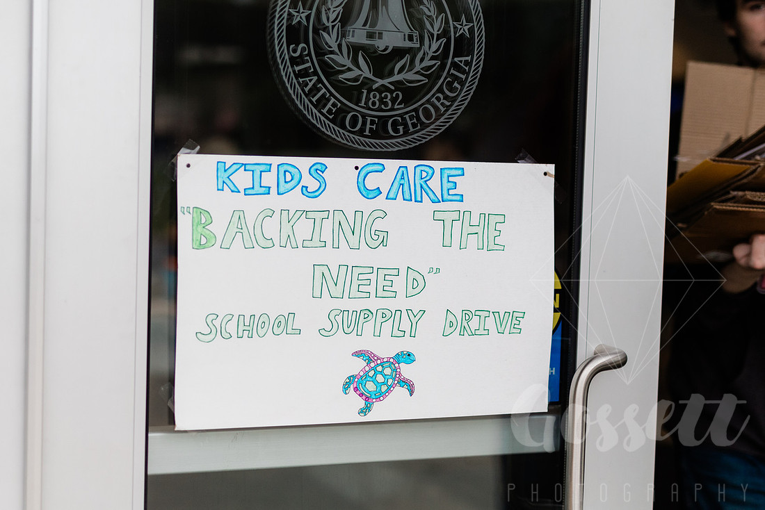 Sign for the school supply drive on the doors of the Cobb County Civic Center