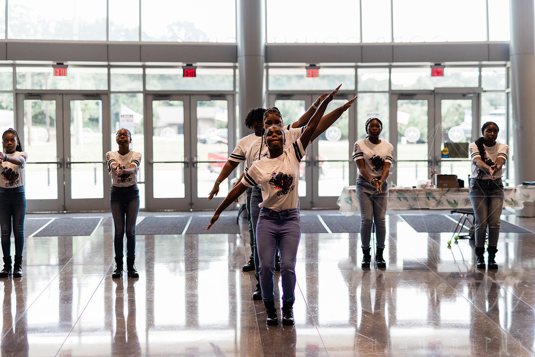 Cobb County Police Athletic League Step Team performs at the school supply league.