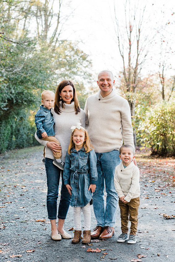 Family poses and enjoys candid moments during a mini session in a park