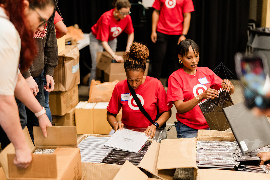 Volunteer team with Target sort school supplies to be delivered.