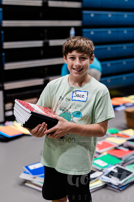 Boy sorts school supplies