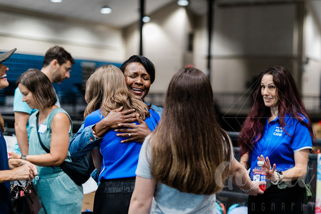 Lisa Cupid hugs founder of service club for kids.