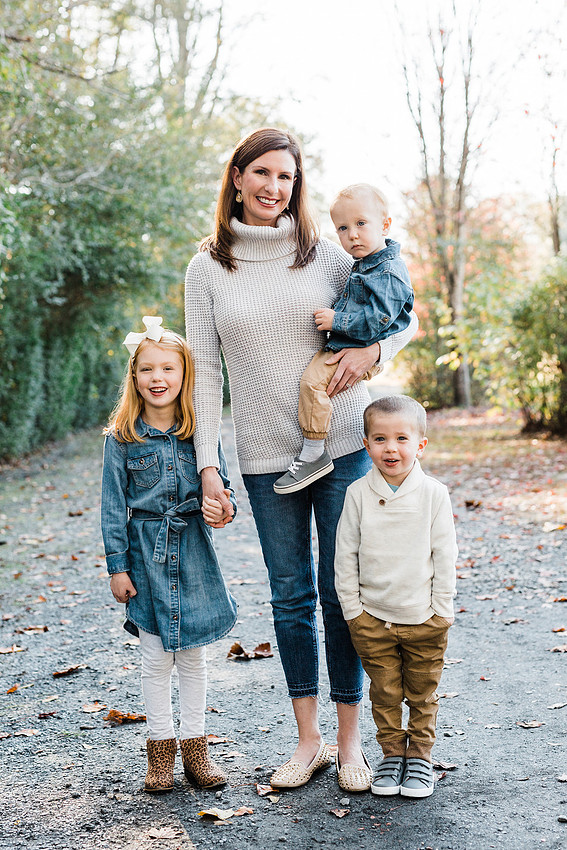 Family poses and enjoys candid moments during a mini session in a park